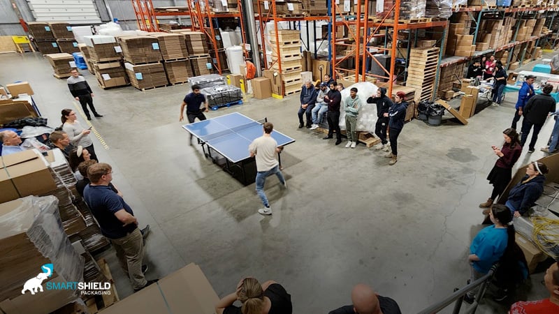 Playing table tennis in the warehouse