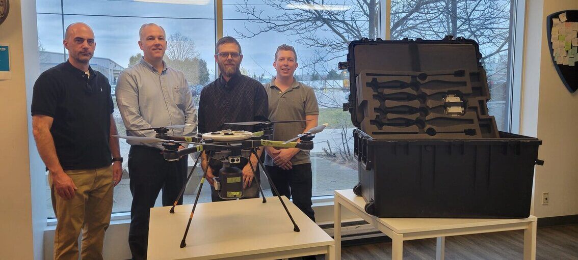 Team standing with custom packaging case for drone